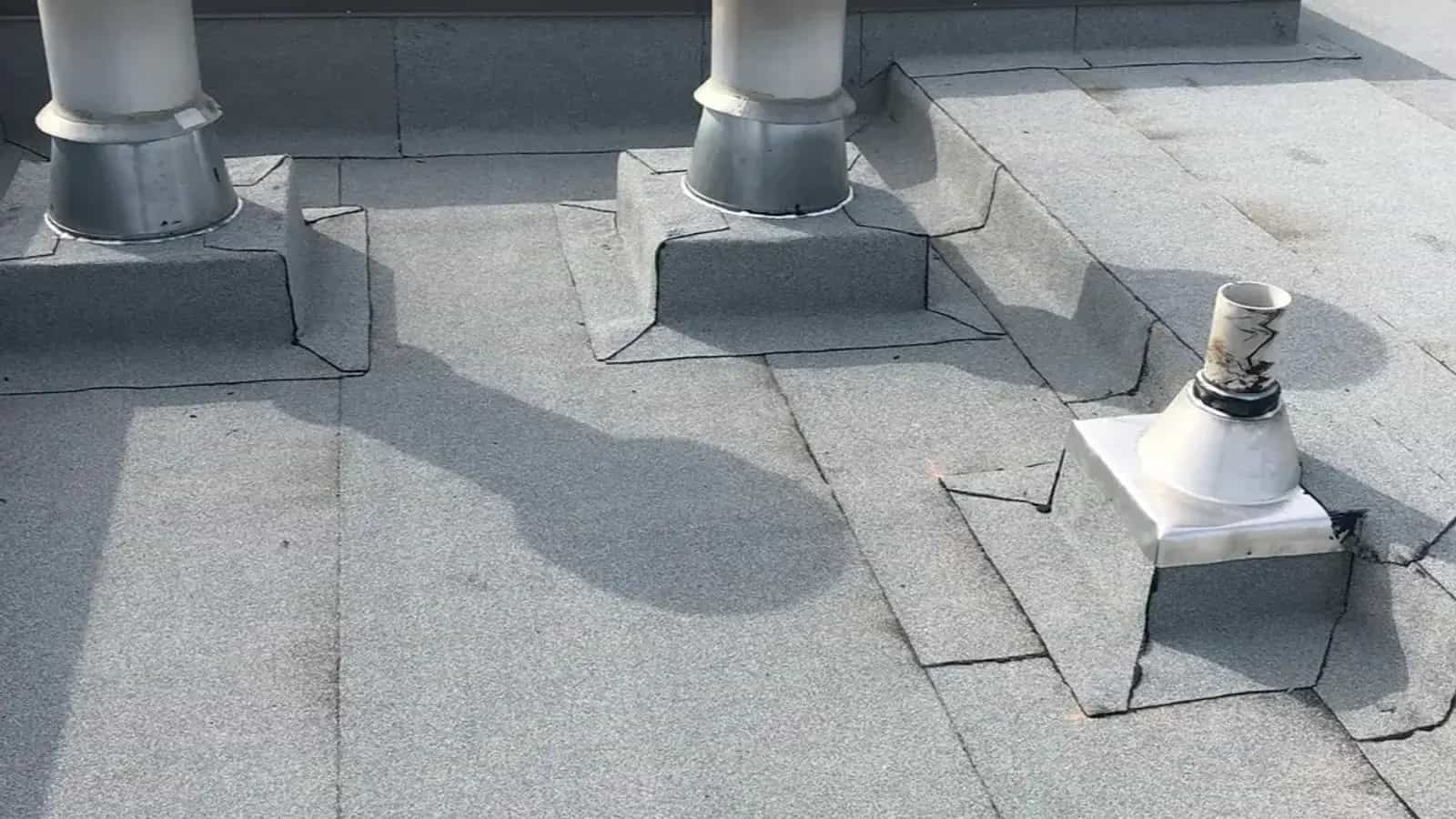 Granulated torch-on membrane roof with vents overlooking city rooftops